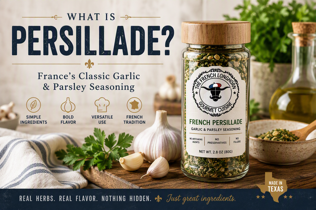 Jar of The French Longhorn French Persillade seasoning with garlic cloves and fresh parsley on a wooden kitchen counter, illustrating a traditional French garlic and parsley seasoning blend.